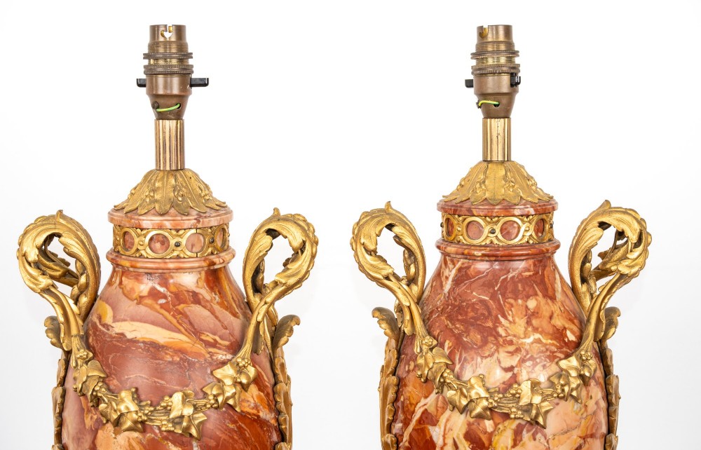 A pair of late nineteenth-century French urn-form table lamps crafted from veined red marble with gilt bronze scroll handles and floral garlands. View XI