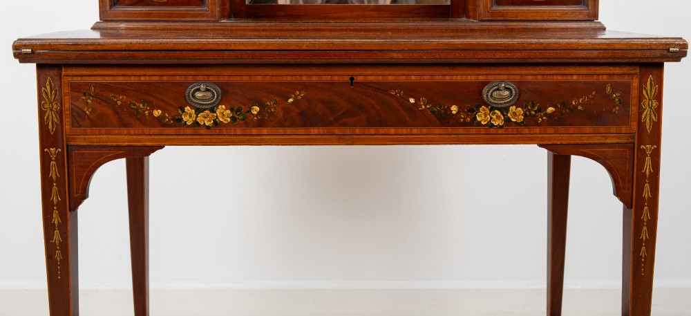 An Edwardian mahogany writing desk featuring floral hand-painted motifs, twin upper cabinets with brass galleries, an arched central mirror, and a single frieze drawer. View VI