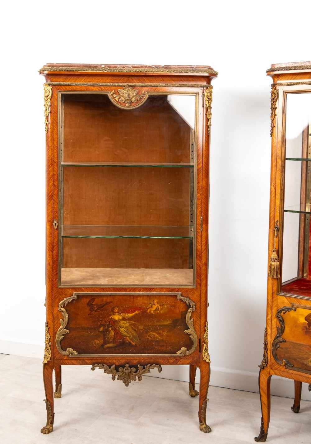 Pair of late 19th-century French kingwood vitrine cabinets featuring marble tops, glass display sections, hand-painted lower panels, and decorative gilt bronze mounts. View IV