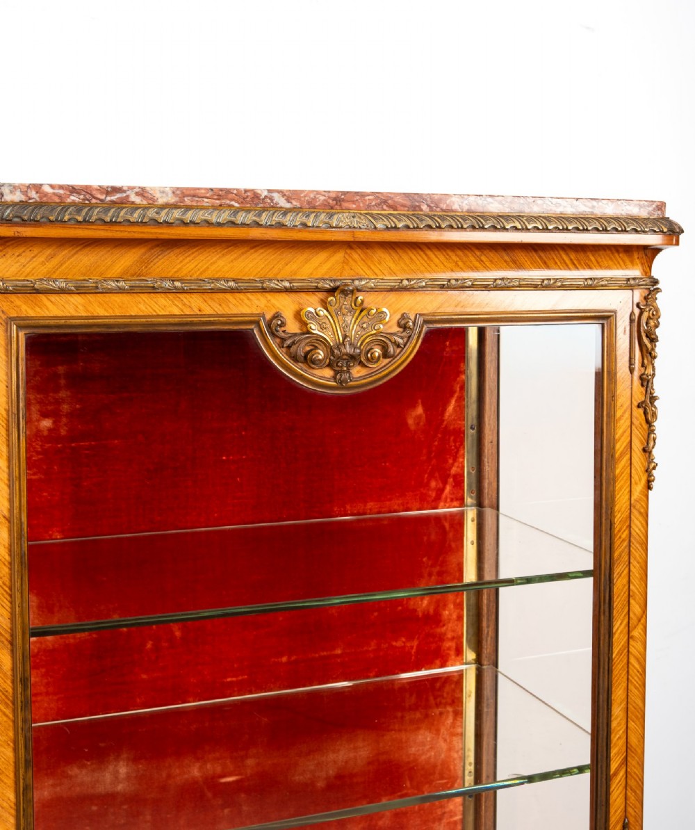 Pair of late 19th-century French kingwood vitrine cabinets featuring marble tops, glass display sections, hand-painted lower panels, and decorative gilt bronze mounts. View VI