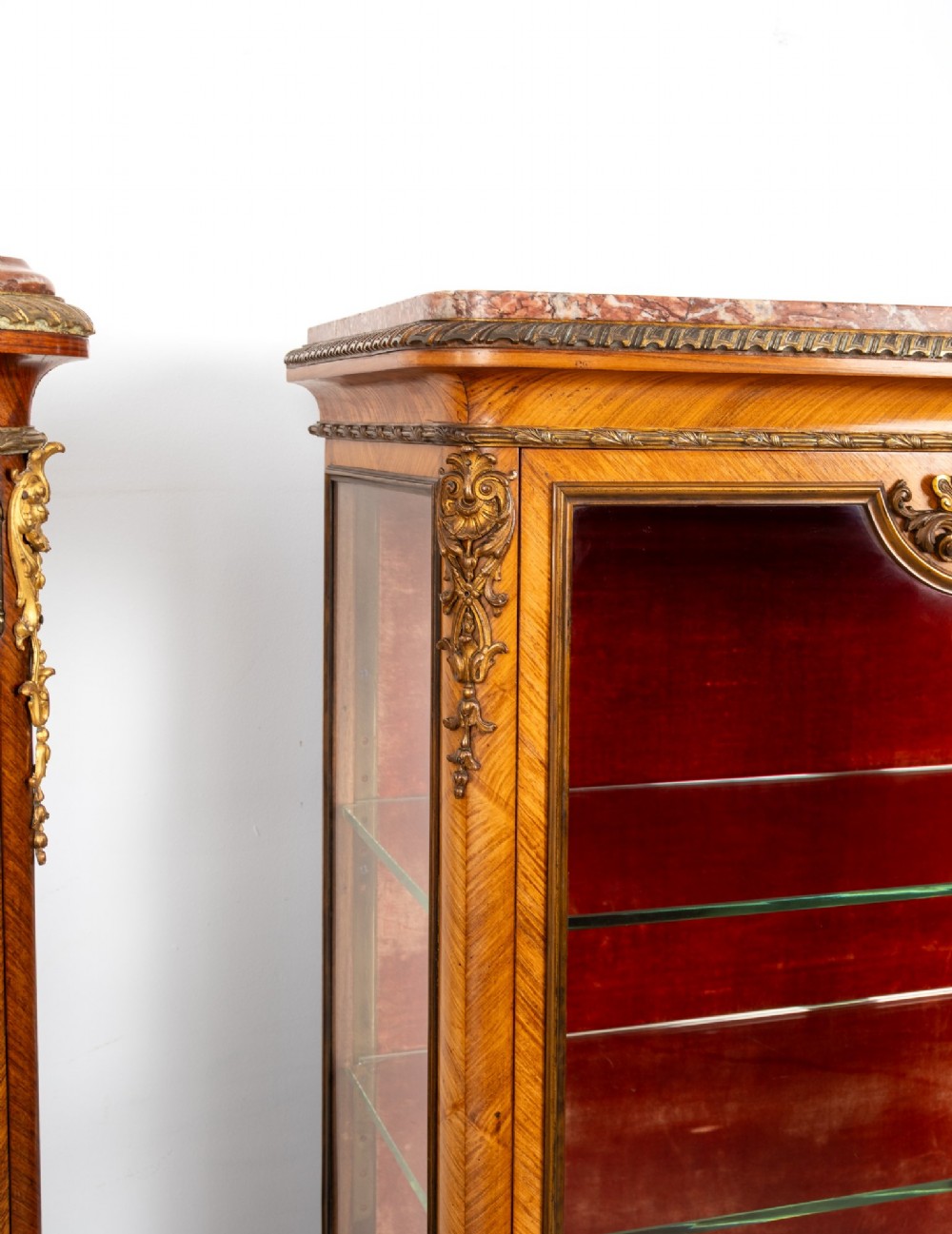 Pair of late 19th-century French kingwood vitrine cabinets featuring marble tops, glass display sections, hand-painted lower panels, and decorative gilt bronze mounts. View VII