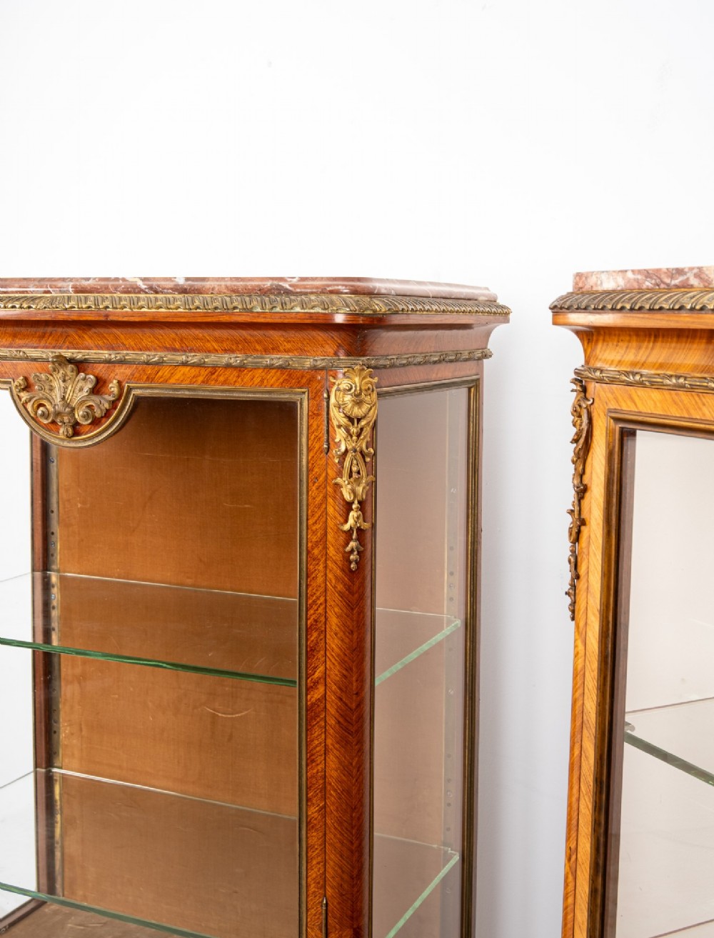 Pair of late 19th-century French kingwood vitrine cabinets featuring marble tops, glass display sections, hand-painted lower panels, and decorative gilt bronze mounts. View VIII