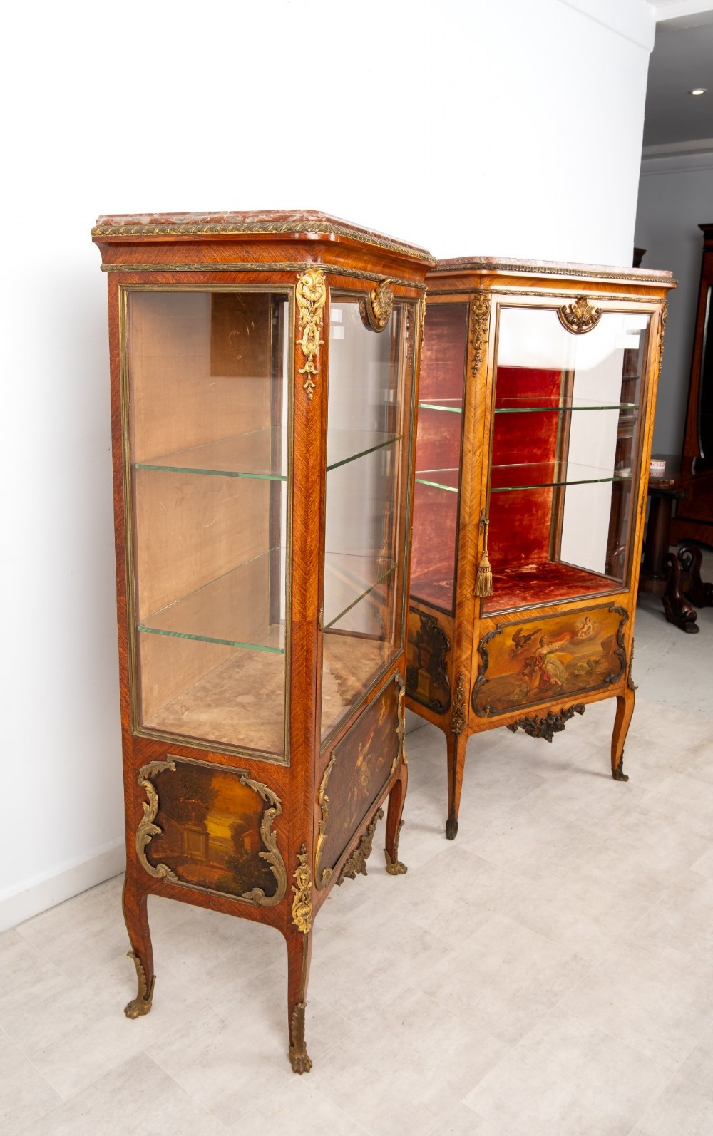 Pair of late 19th-century French kingwood vitrine cabinets featuring marble tops, glass display sections, hand-painted lower panels, and decorative gilt bronze mounts. View XII