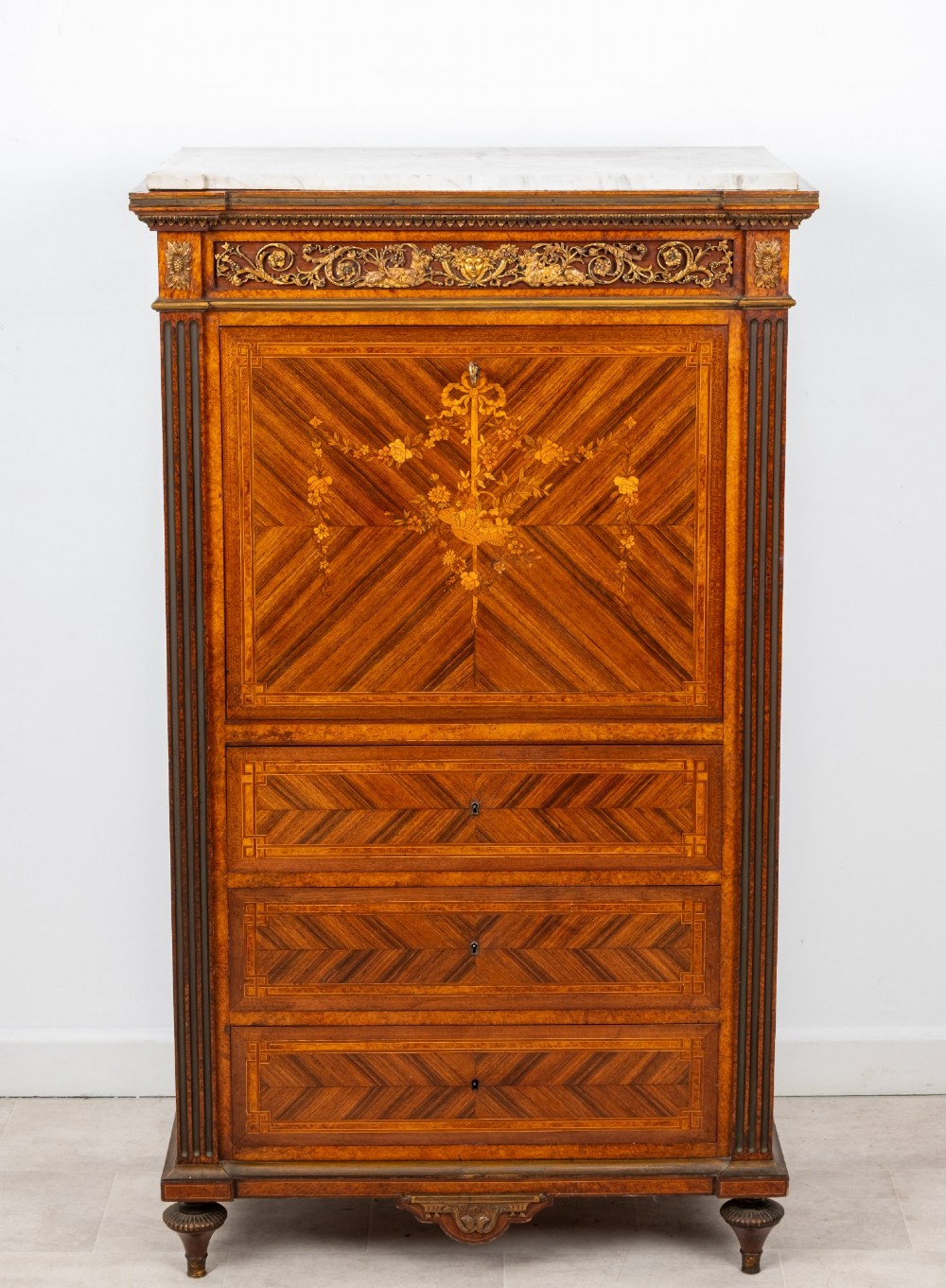 An antique nineteenth-century French parquetry secretaire a abattant writing desk featuring geometric veneer patterns, floral marquetry, gilt bronze mounts, and a marble top. View III