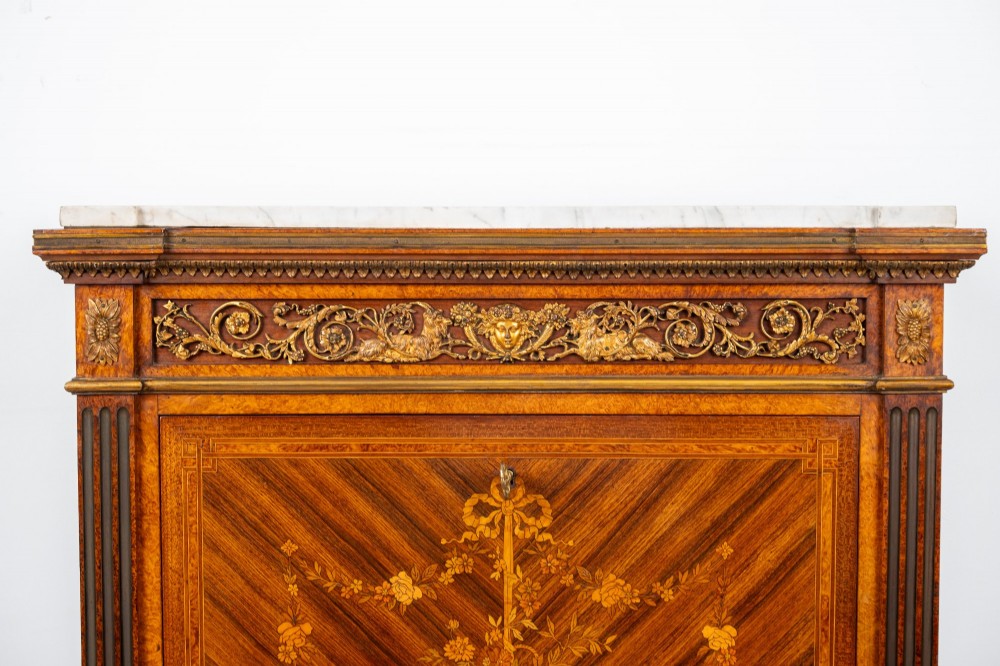 An antique nineteenth-century French parquetry secretaire a abattant writing desk featuring geometric veneer patterns, floral marquetry, gilt bronze mounts, and a marble top. View IV