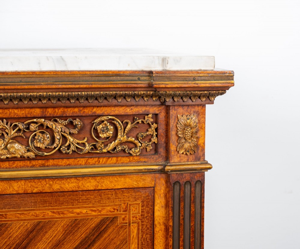 An antique nineteenth-century French parquetry secretaire a abattant writing desk featuring geometric veneer patterns, floral marquetry, gilt bronze mounts, and a marble top. View V