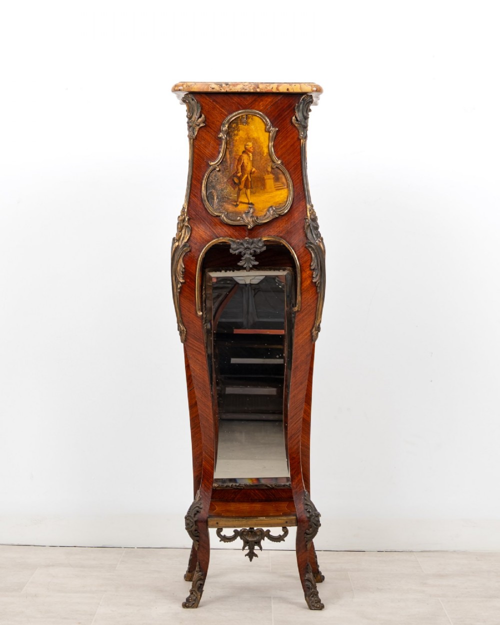 A tall French Rococo style kingwood pedestal stand featuring a marble top, gilt bronze mounts, a hand-painted Vernis Martin scene, and a mirrored lower alcove.