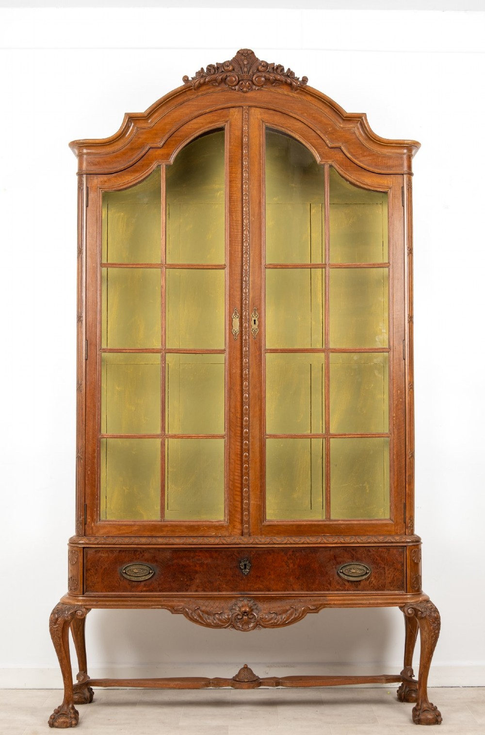 A Queen Anne Revival walnut display cabinet featuring a shaped pediment, double glazed doors, a single lower drawer, and carved cabriole legs. View III