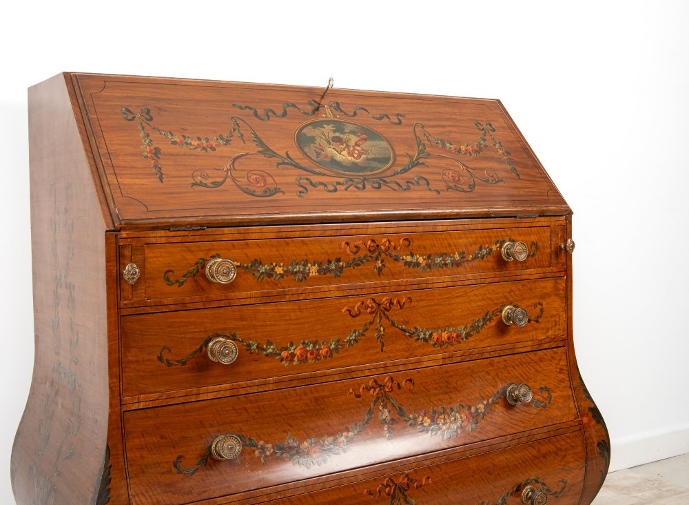 An Edwardian satinwood slant-front bureau with hand-painted floral swags, ribbon garlands, four drawers, and bracket feet. View VI