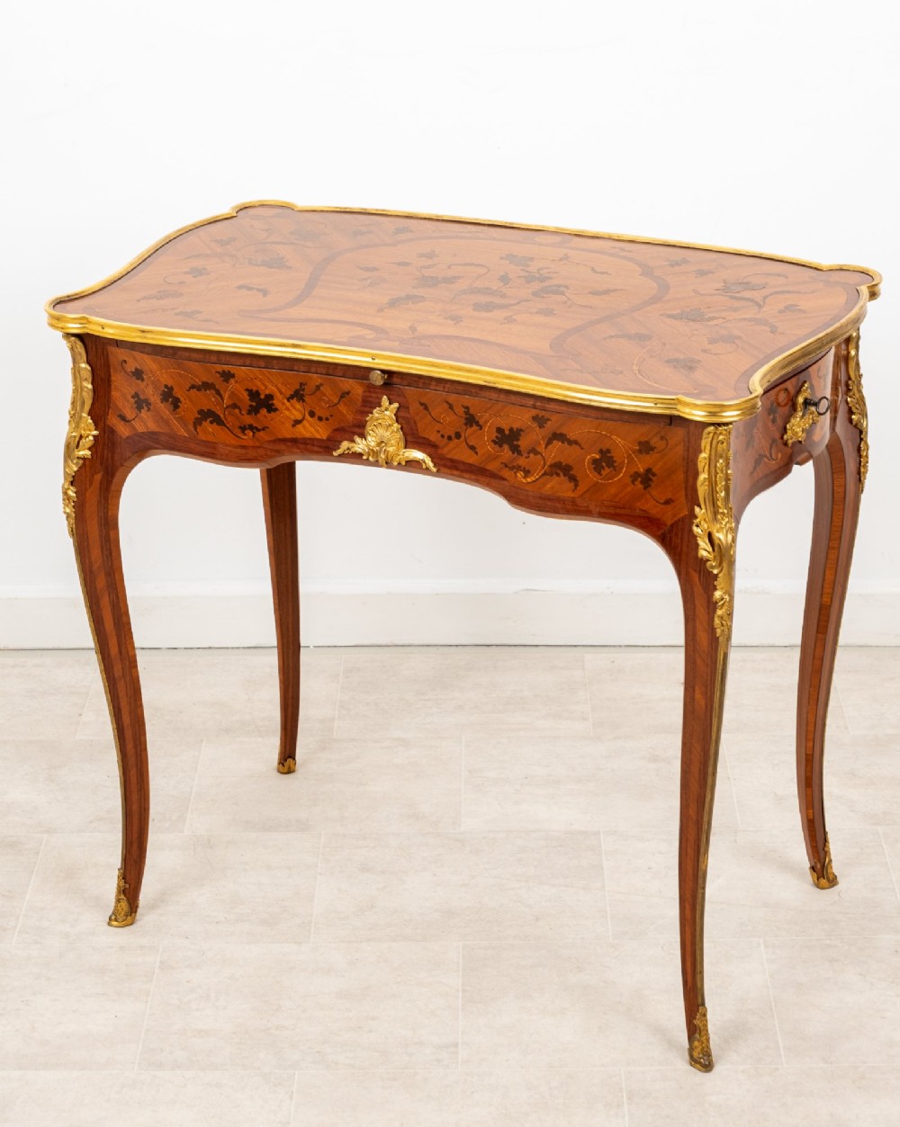 A French Louis XV style kingwood bureau plat featuring floral marquetry inlay, curved cabriole legs, and gilt-bronze mounts. View III