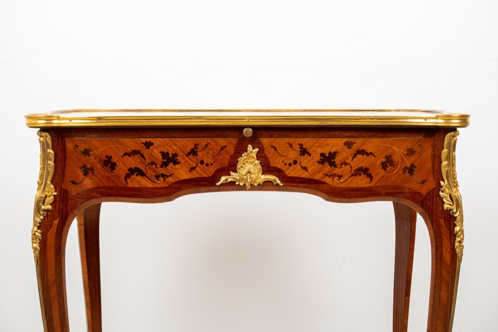 A French Louis XV style kingwood bureau plat featuring floral marquetry inlay, curved cabriole legs, and gilt-bronze mounts. View IV