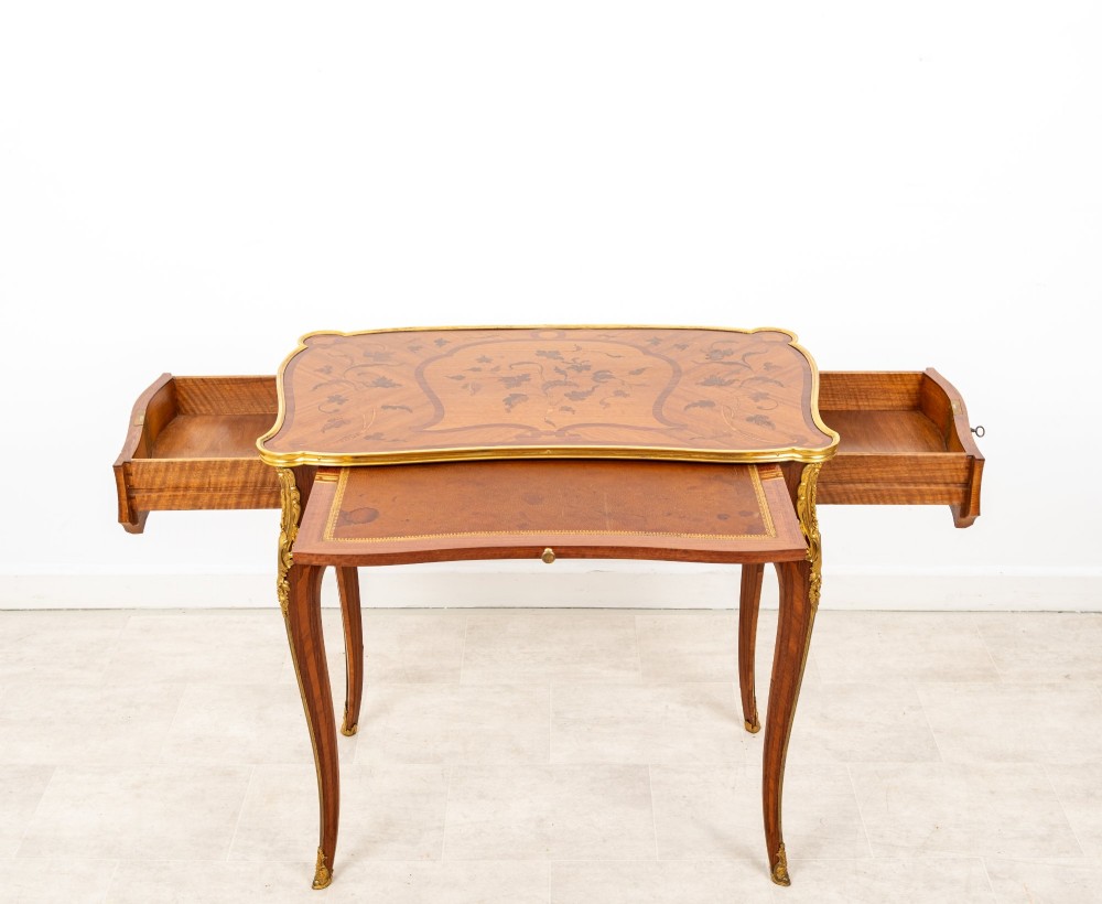 A French Louis XV style kingwood bureau plat featuring floral marquetry inlay, curved cabriole legs, and gilt-bronze mounts. View VII