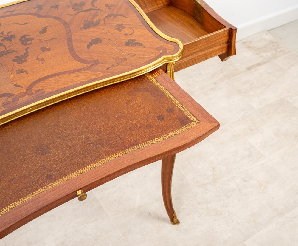 A French Louis XV style kingwood bureau plat featuring floral marquetry inlay, curved cabriole legs, and gilt-bronze mounts. View VIII