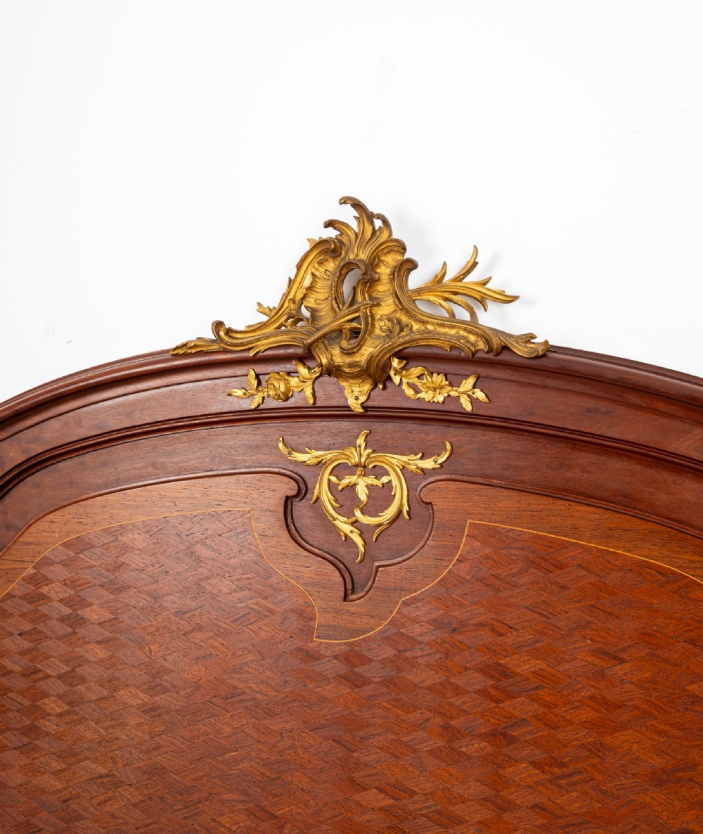 An antique French Louis XV style bedstead crafted from kingwood with geometric parquetry veneers and gilded bronze ormolu mounts. View VII