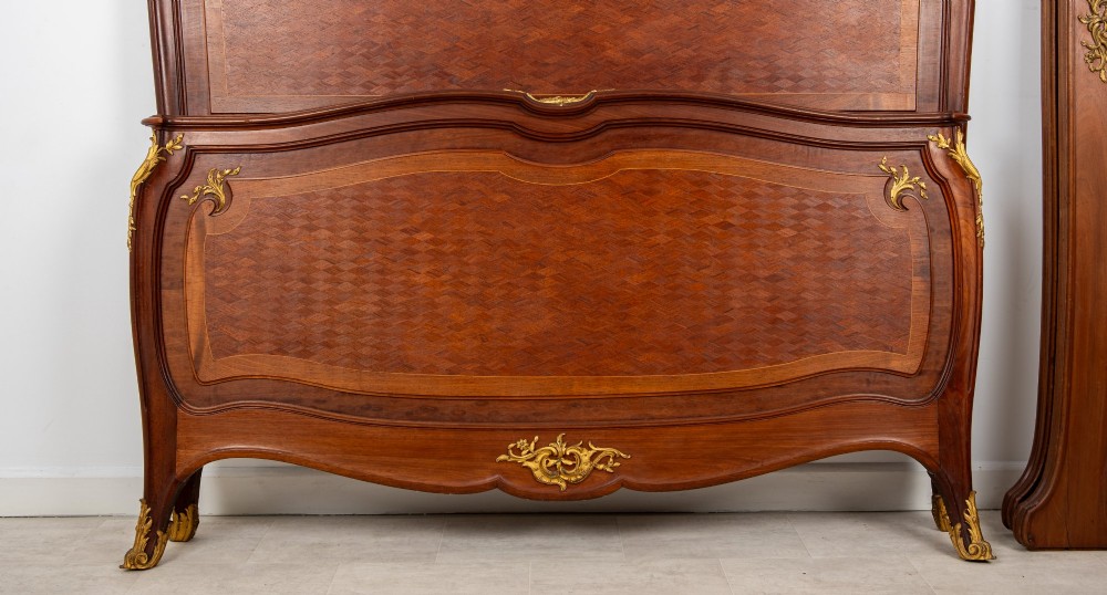 An antique French Louis XV style bedstead crafted from kingwood with geometric parquetry veneers and gilded bronze ormolu mounts. View VIII