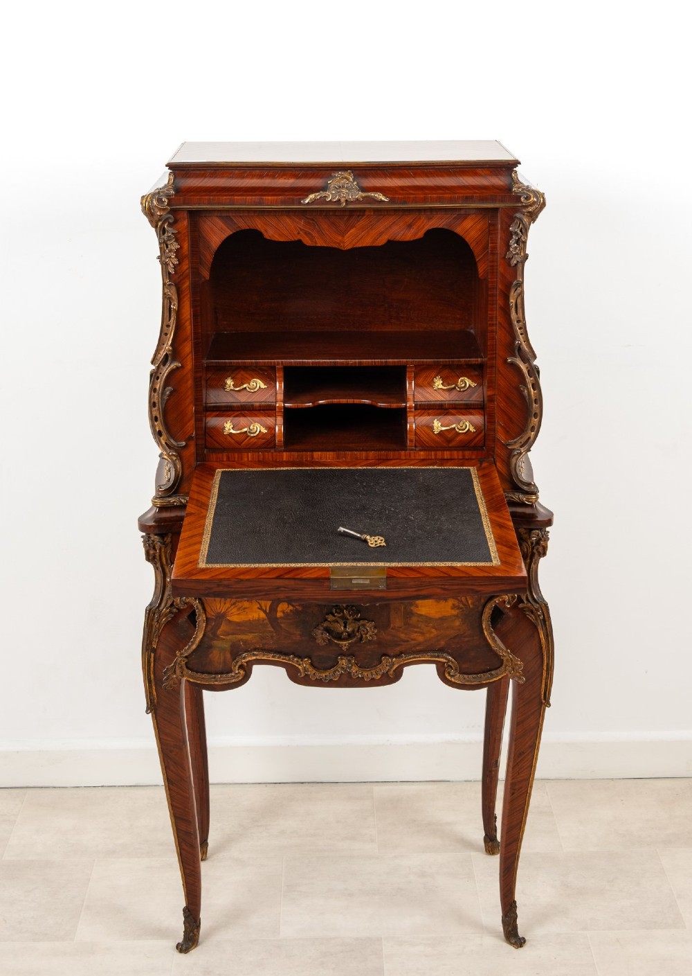 A French Louis XV style kingwood secretaire a abattant on cabriole legs, decorated with gilt bronze mounts and a hand-painted Vernis Martin scene on the fall-front flap. View IX