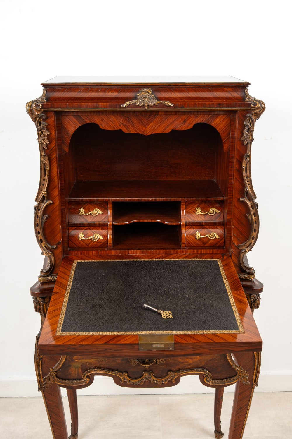 A French Louis XV style kingwood secretaire a abattant on cabriole legs, decorated with gilt bronze mounts and a hand-painted Vernis Martin scene on the fall-front flap. View X