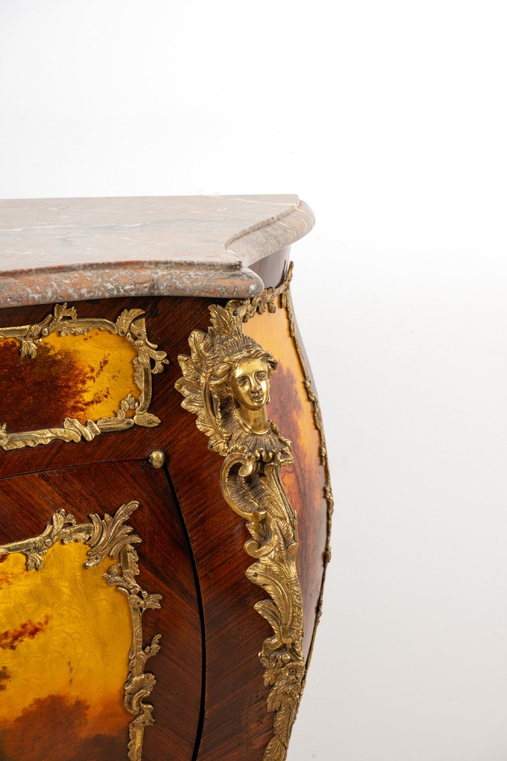 An antique French Vernis Martin bombe cabinet featuring hand-painted pastoral scenes on a curved door, ornate gilt-bronze mounts, and a marble top. View V