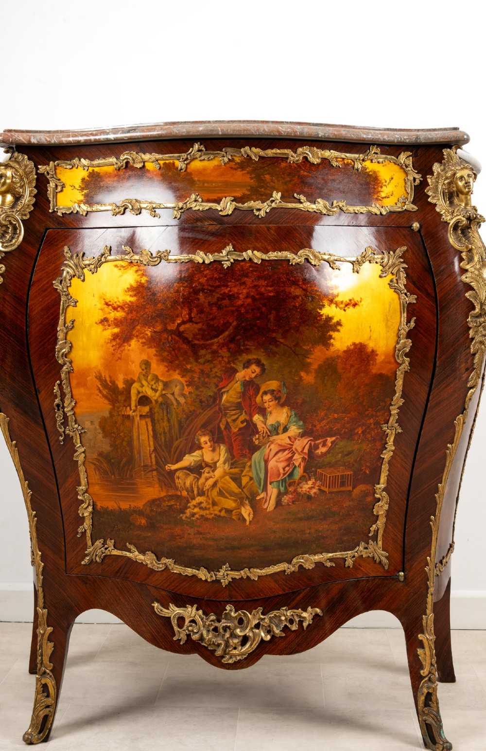 An antique French Vernis Martin bombe cabinet featuring hand-painted pastoral scenes on a curved door, ornate gilt-bronze mounts, and a marble top. View VIII