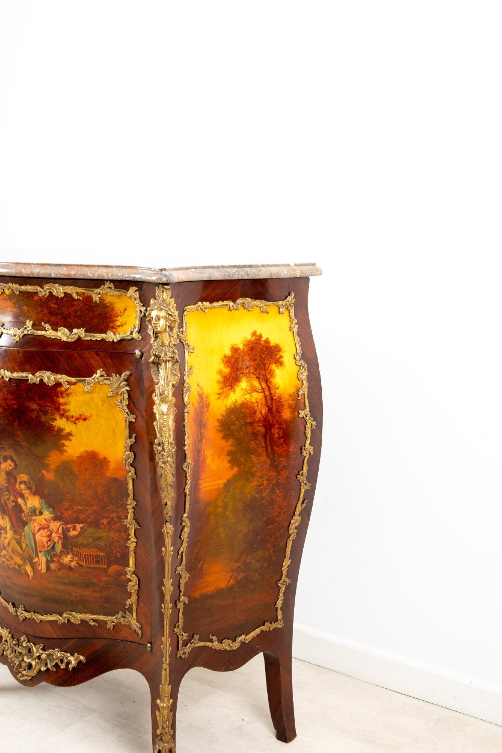 An antique French Vernis Martin bombe cabinet featuring hand-painted pastoral scenes on a curved door, ornate gilt-bronze mounts, and a marble top. View X