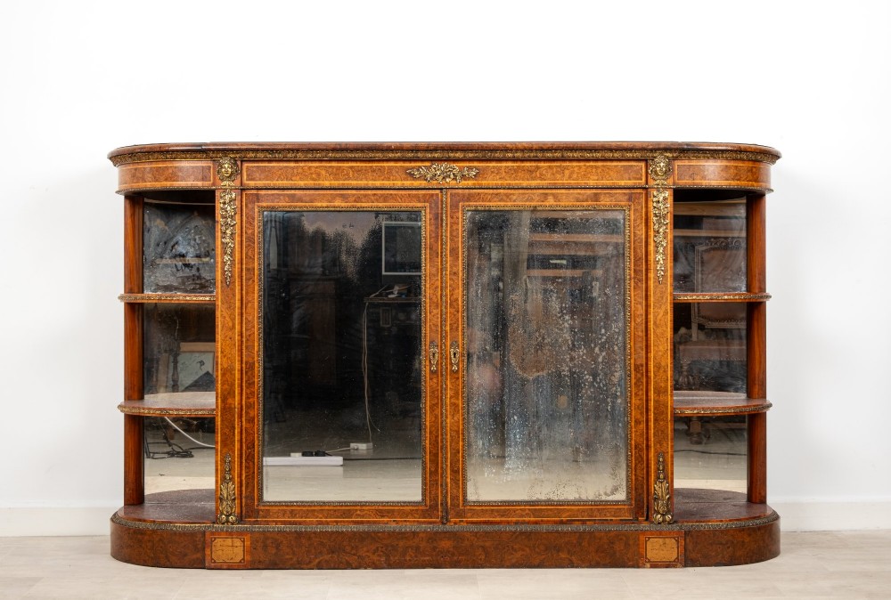 A Victorian burr walnut credenza featuring central mirrored doors, open curved side shelves, and detailed gilt ormolu mounts. View II