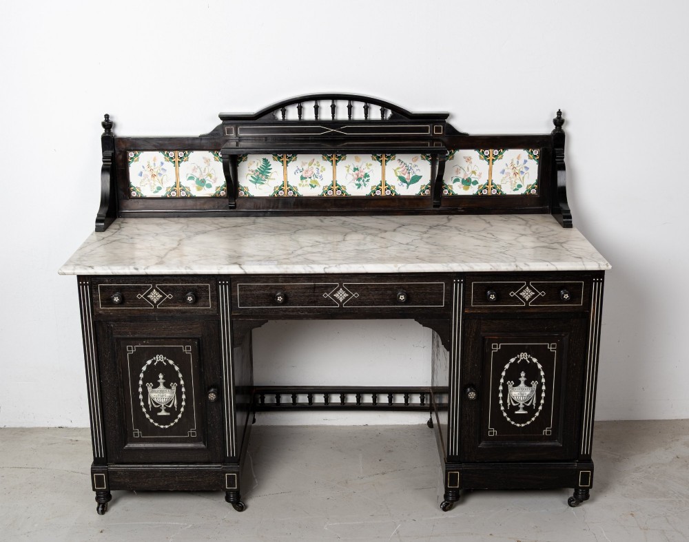 A six-piece late Victorian ebonised bedroom suite featuring bone inlay, comprising a half-tester bed, mirror wardrobe, dressing table, marble-top washstand, nightstand, and towel rail. View VII