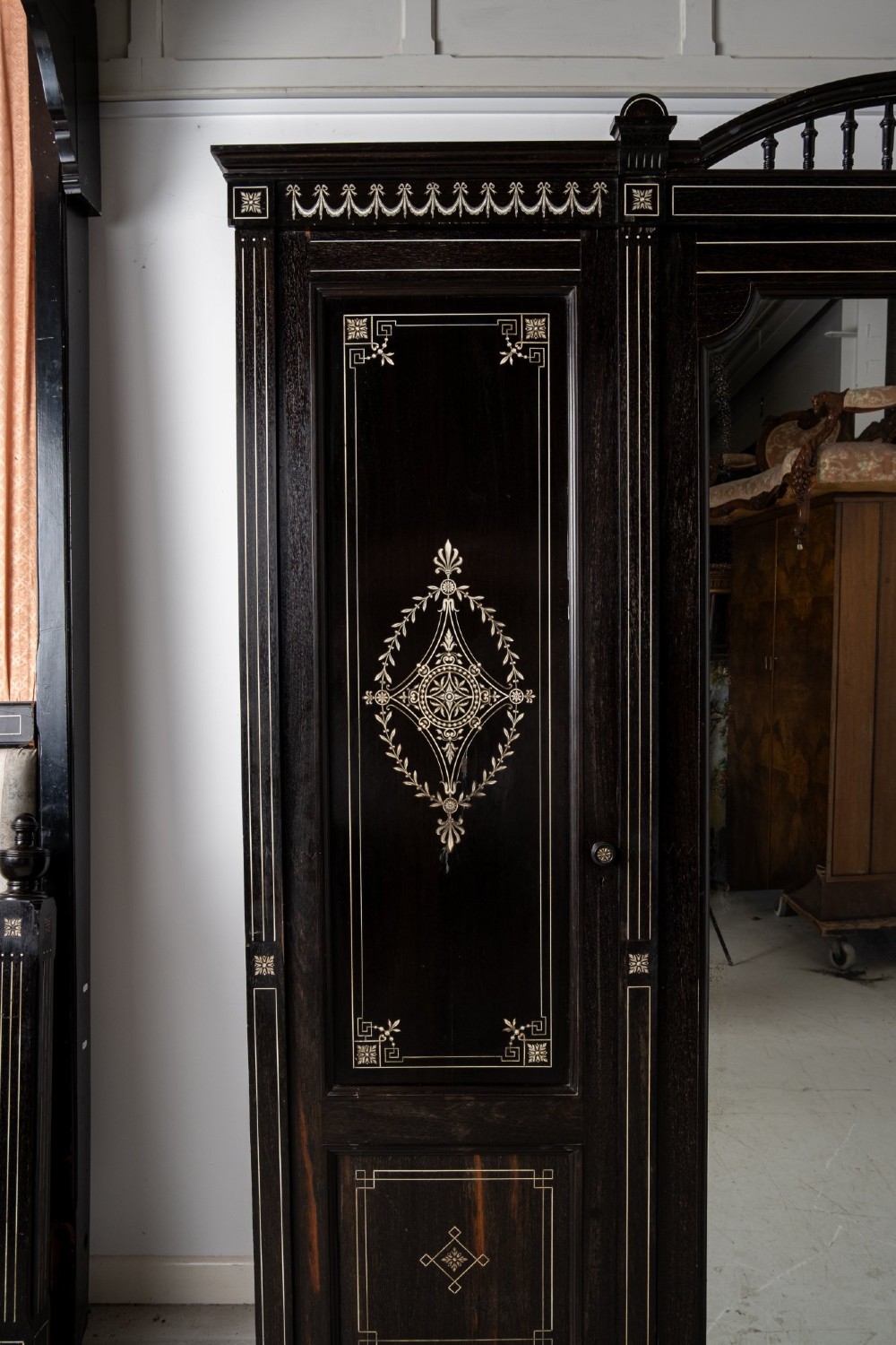 A six-piece late Victorian ebonised bedroom suite featuring bone inlay, comprising a half-tester bed, mirror wardrobe, dressing table, marble-top washstand, nightstand, and towel rail. View VIII