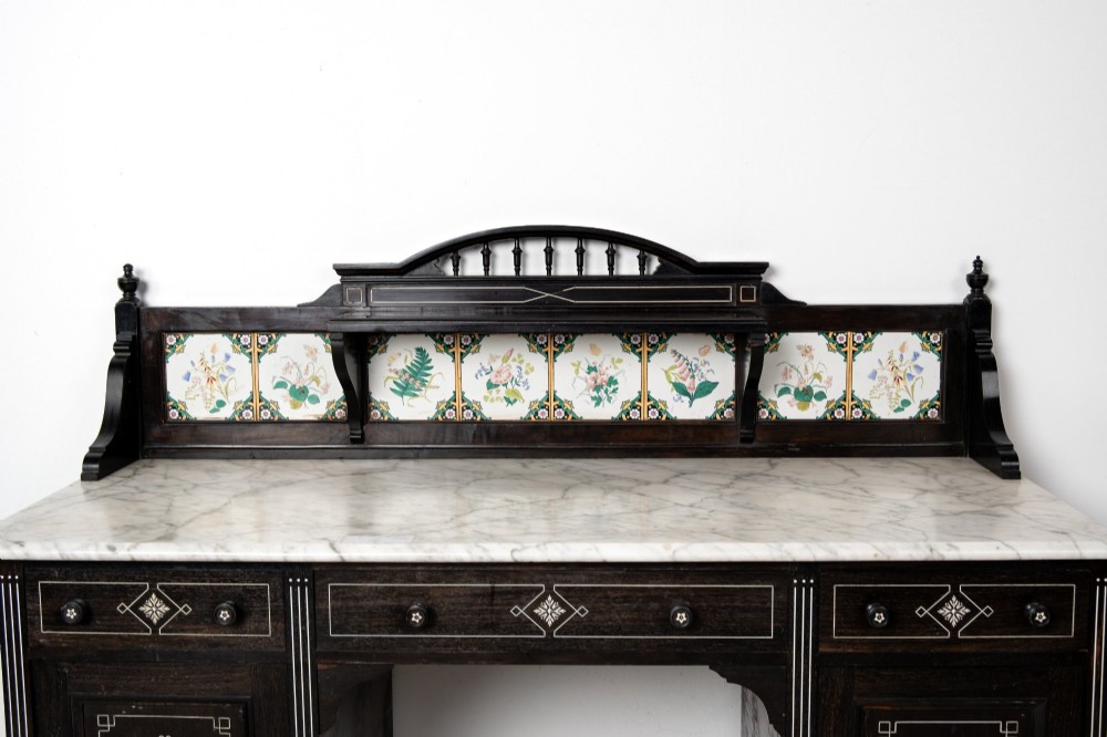 A six-piece late Victorian ebonised bedroom suite featuring bone inlay, comprising a half-tester bed, mirror wardrobe, dressing table, marble-top washstand, nightstand, and towel rail. View IX