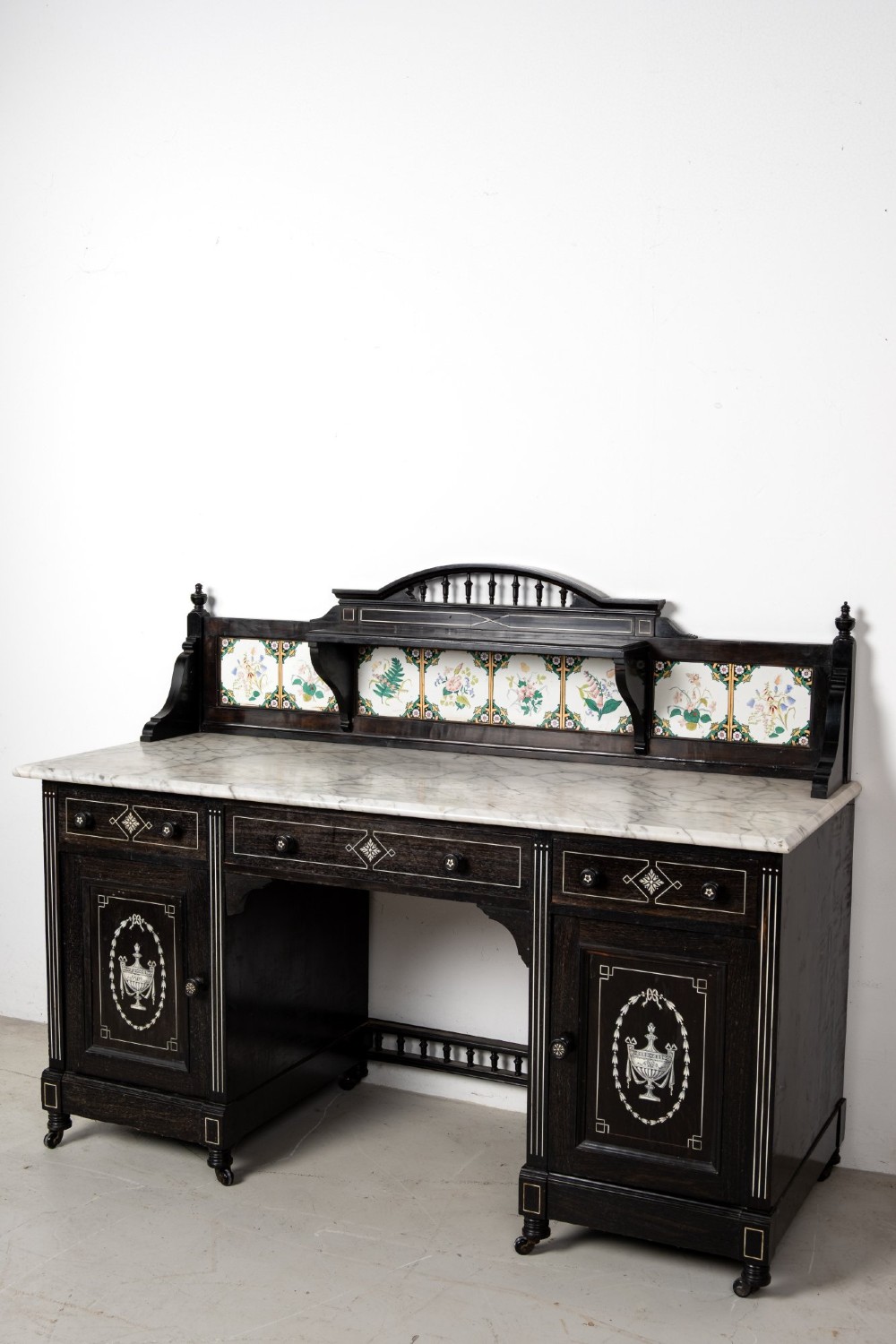 A six-piece late Victorian ebonised bedroom suite featuring bone inlay, comprising a half-tester bed, mirror wardrobe, dressing table, marble-top washstand, nightstand, and towel rail. View XI