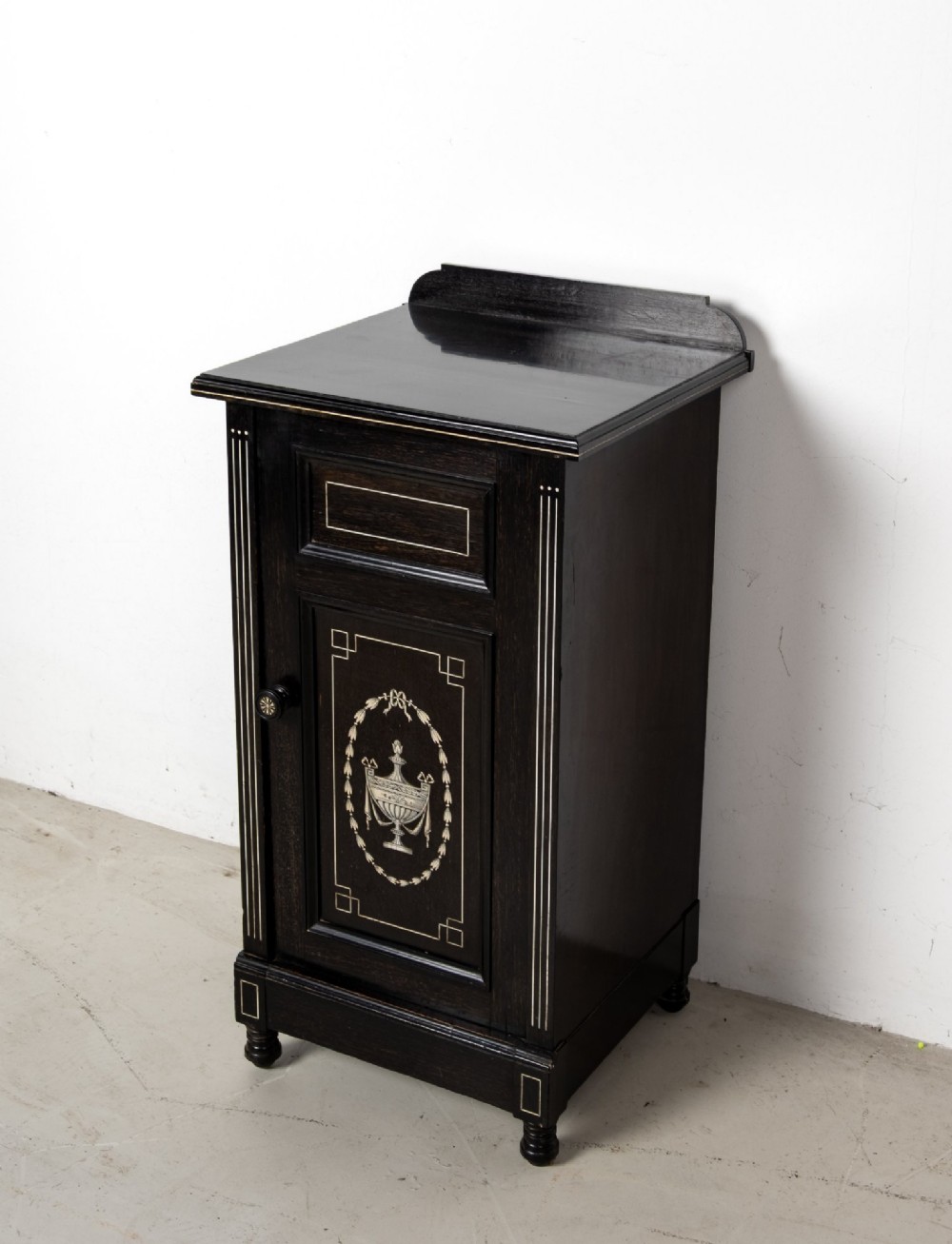 A six-piece late Victorian ebonised bedroom suite featuring bone inlay, comprising a half-tester bed, mirror wardrobe, dressing table, marble-top washstand, nightstand, and towel rail. View XII