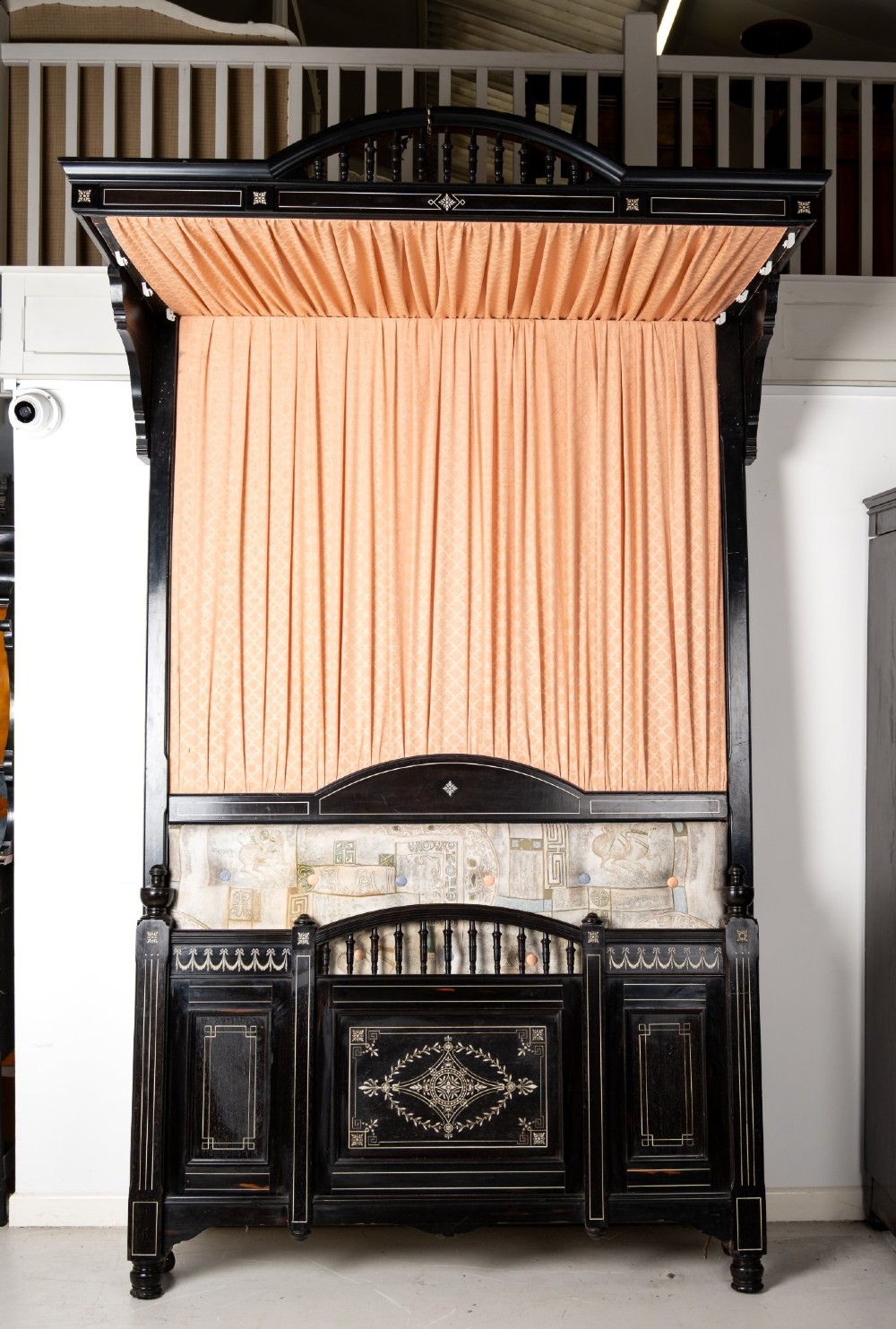 A six-piece late Victorian ebonised bedroom suite featuring bone inlay, comprising a half-tester bed, mirror wardrobe, dressing table, marble-top washstand, nightstand, and towel rail. View XIV