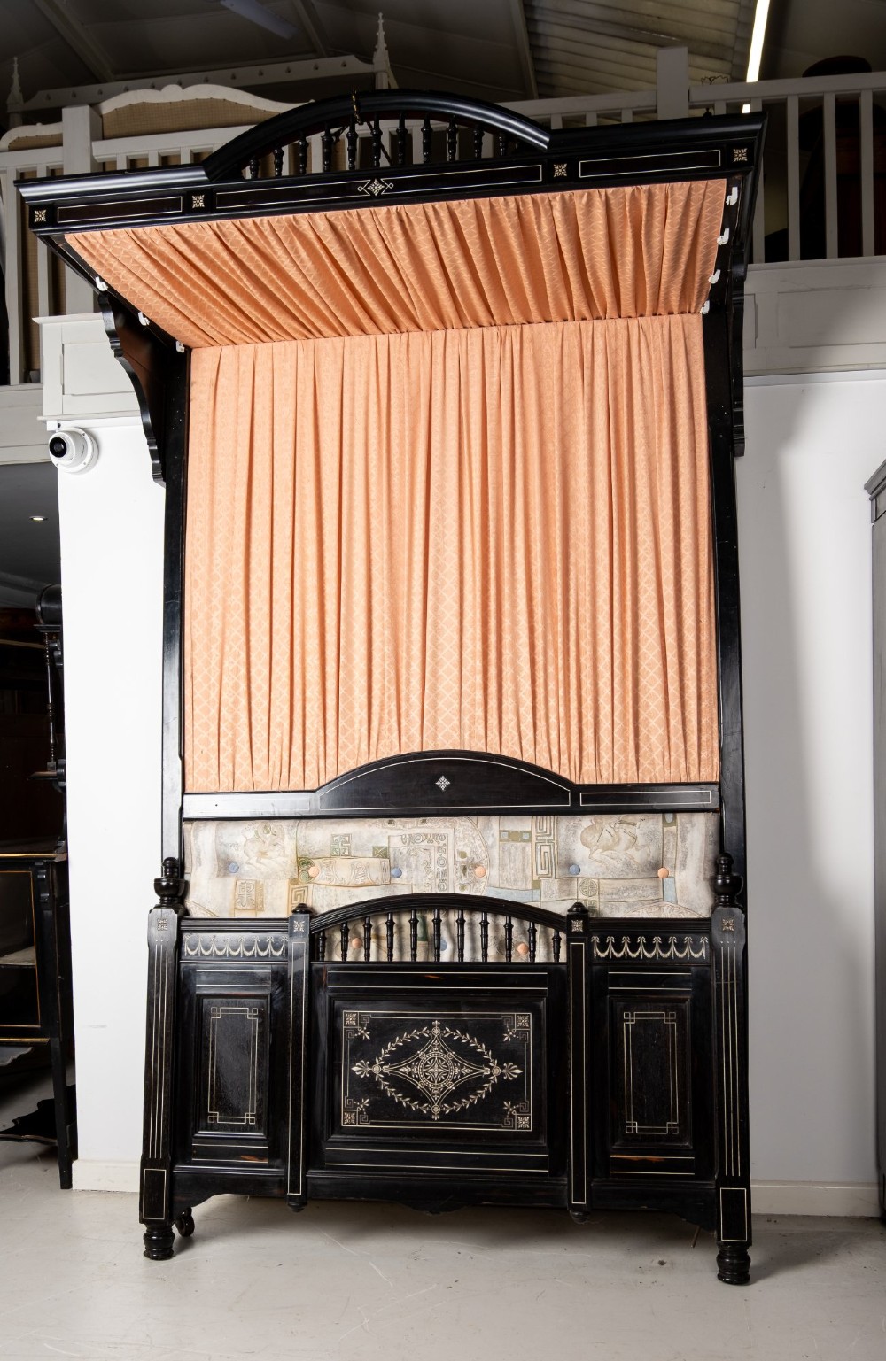 A six-piece late Victorian ebonised bedroom suite featuring bone inlay, comprising a half-tester bed, mirror wardrobe, dressing table, marble-top washstand, nightstand, and towel rail. View XV