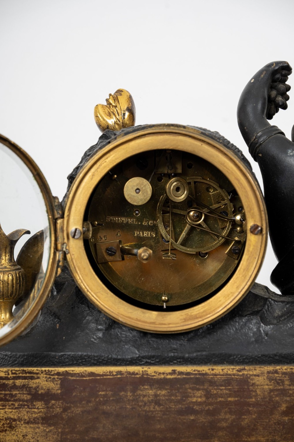 A French 19th-century figural mantel clock with a patinated bronze cherub beside a circular white enamel dial on a gilt-bronze and marble base. View XI
