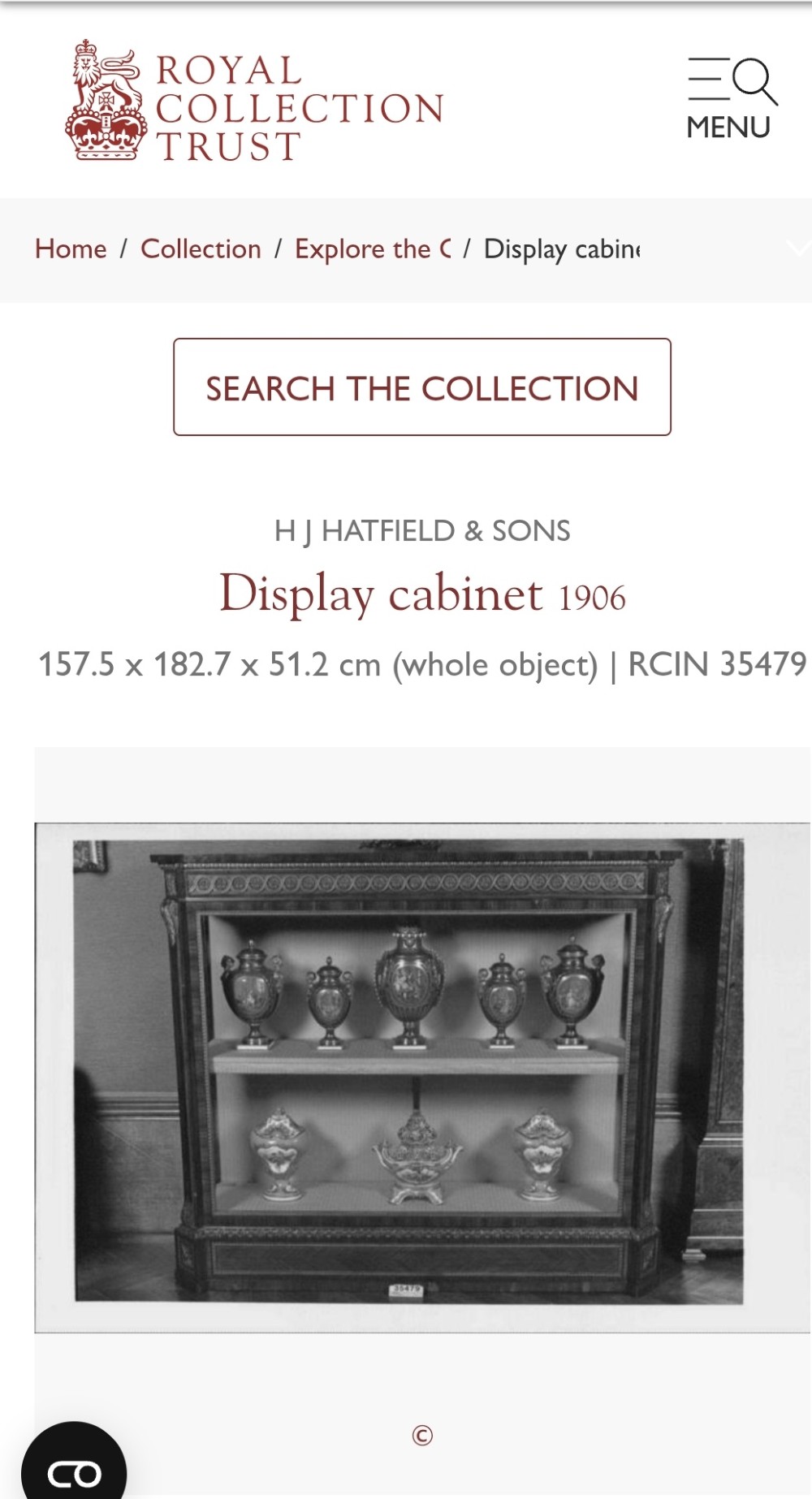 A large veneered display cabinet featuring gilt-bronze mounts, glazed twin doors, glass shelving, and a fabric-lined interior. View XIV