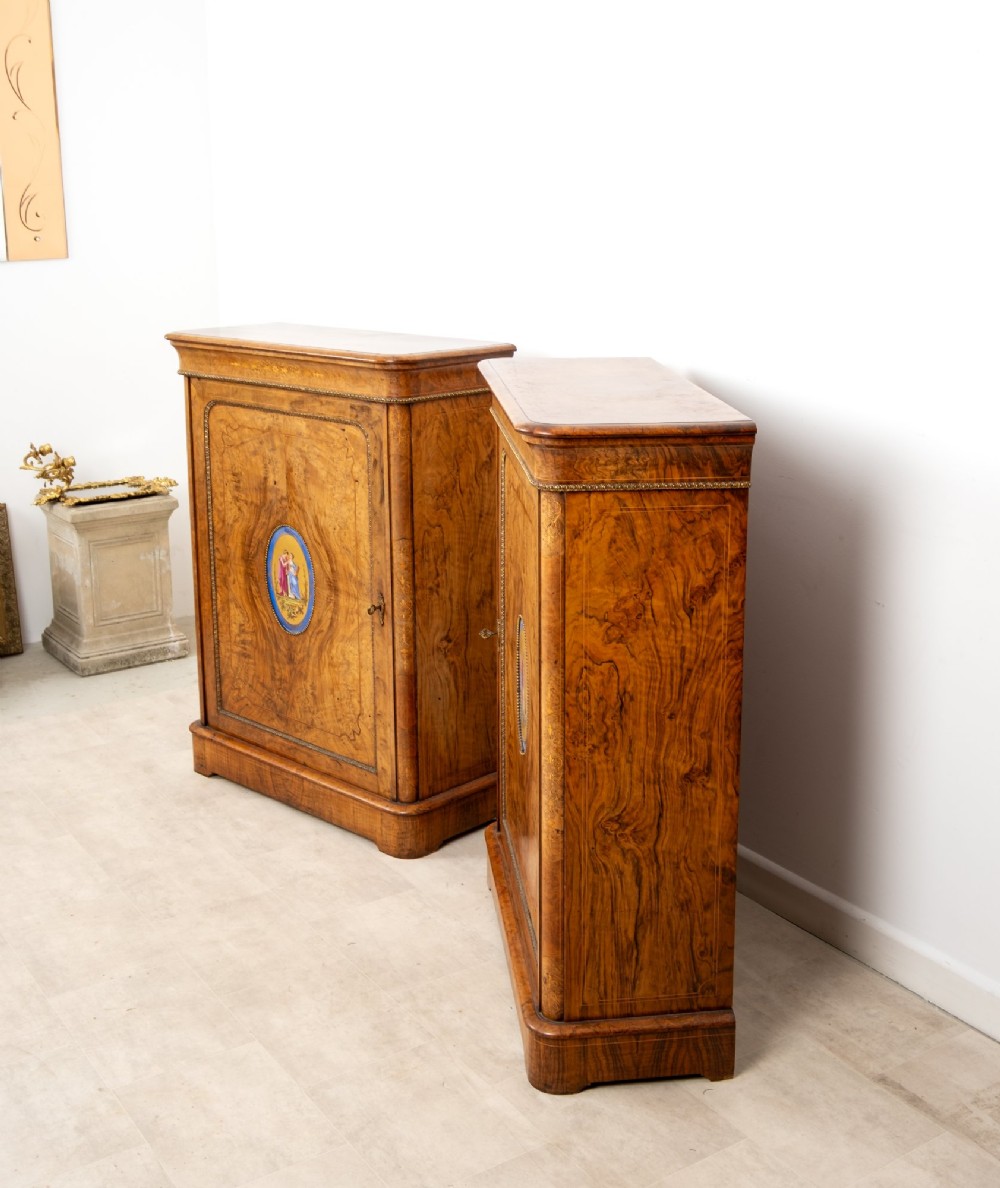 A pair of Victorian burr walnut side cabinets featuring inlaid boxwood detailing, gilt metal trim, and central oval blue porcelain plaques painted with classical figures. View VIII