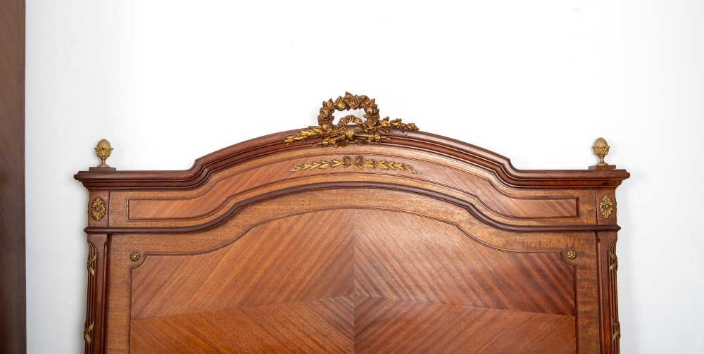 A French Louis XVI Revival mahogany bedroom suite comprising a mirrored two-door armoire, a matching bedframe with parquetry detailing, and a marble-topped bedside table with gilded bronze mounts. View VII