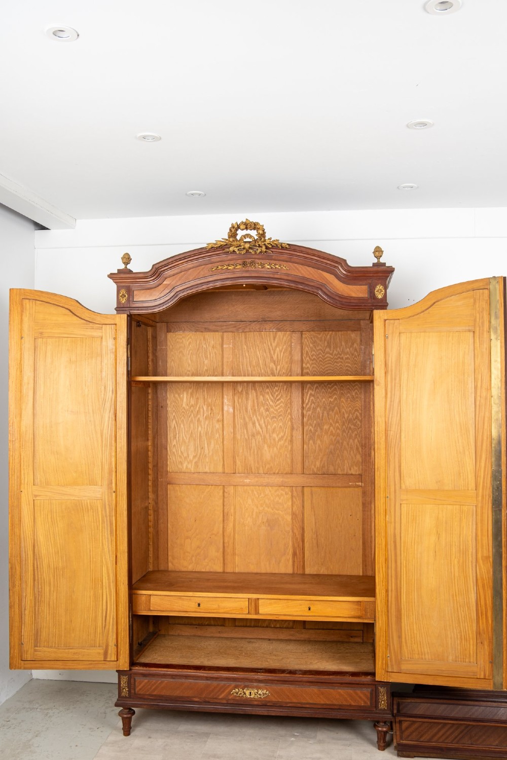 A French Louis XVI Revival mahogany bedroom suite comprising a mirrored two-door armoire, a matching bedframe with parquetry detailing, and a marble-topped bedside table with gilded bronze mounts. View IX