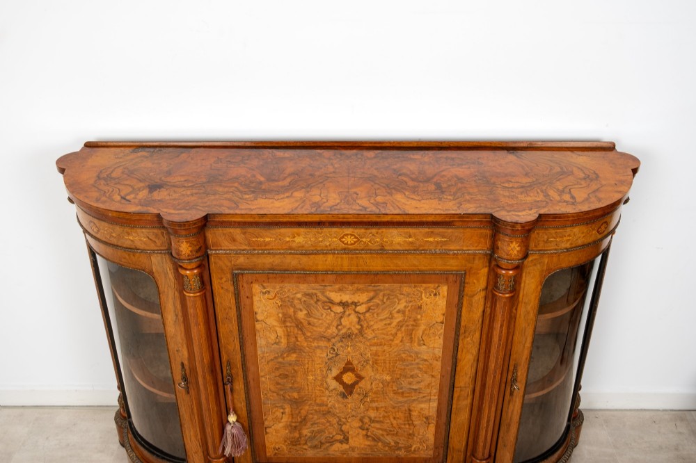 An antique Victorian burr walnut credenza featuring a central inlaid marquetry door flanked by two curved glazed display cabinets and gilt mounts. View VII