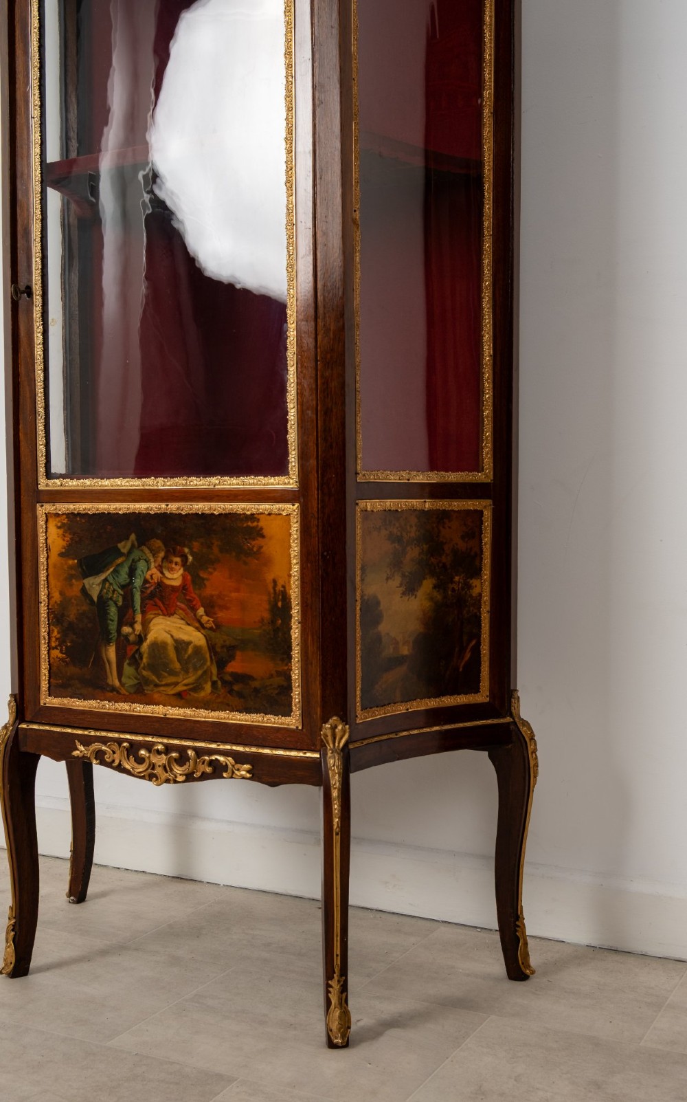 An antique French mahogany vitrine display cabinet featuring hand-painted Vernis Martin panels, gilt bronze mounts, cabriole legs, and a red velvet interior. View VIII