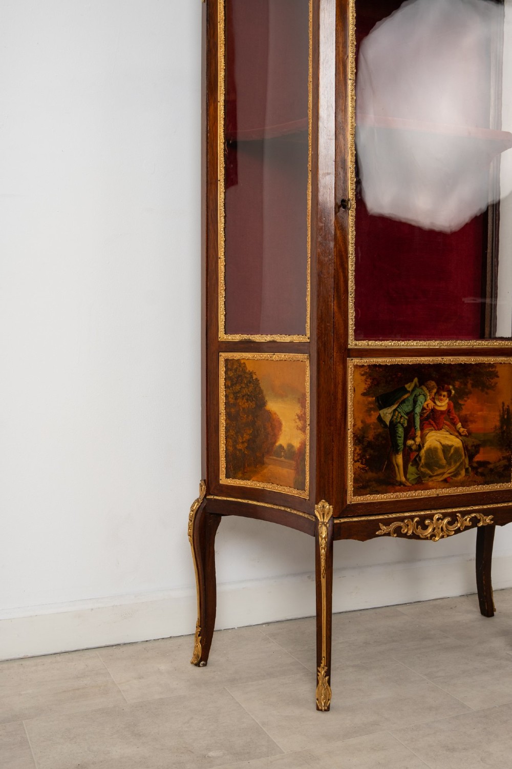 An antique French mahogany vitrine display cabinet featuring hand-painted Vernis Martin panels, gilt bronze mounts, cabriole legs, and a red velvet interior. View IX