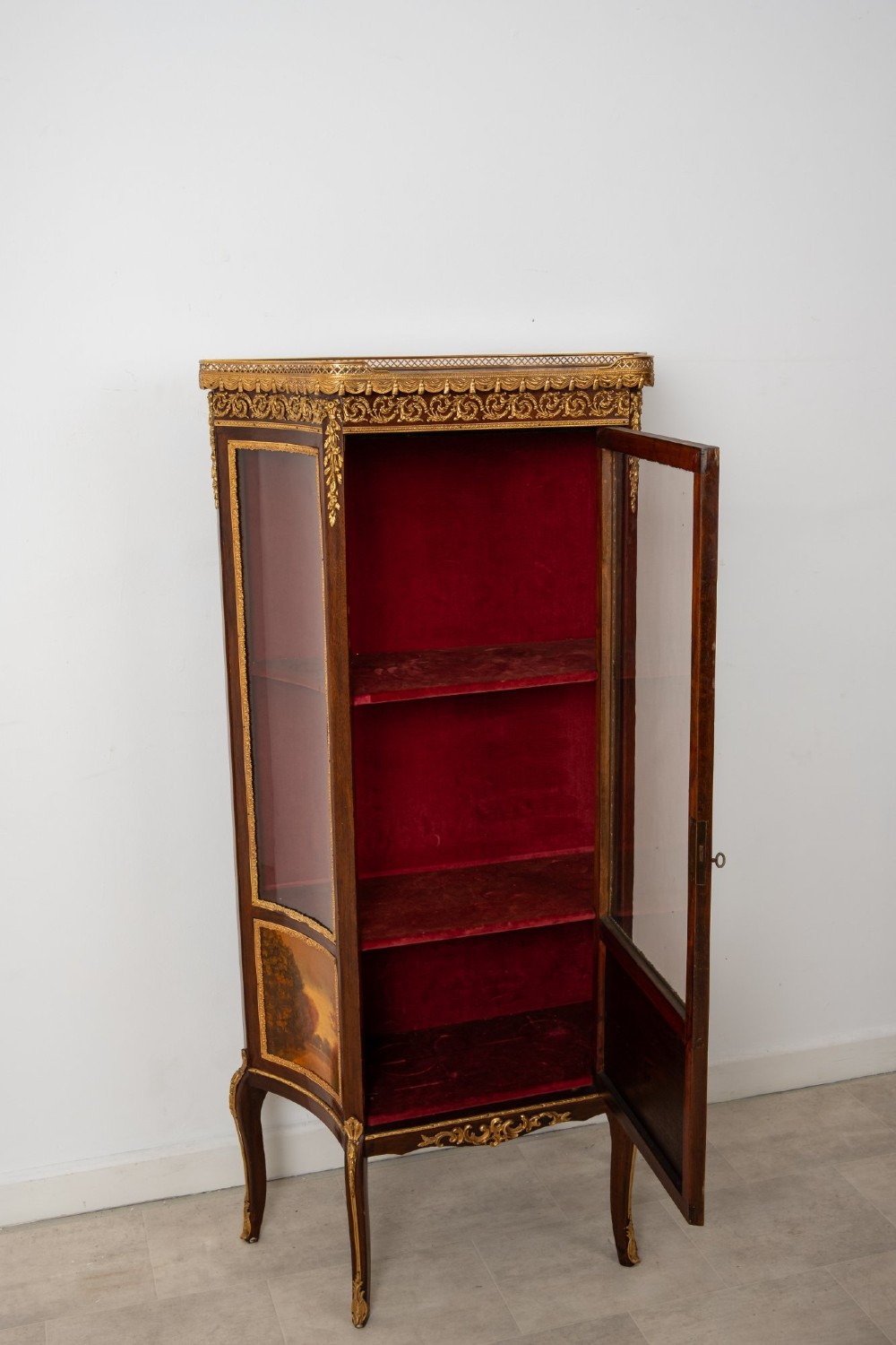 An antique French mahogany vitrine display cabinet featuring hand-painted Vernis Martin panels, gilt bronze mounts, cabriole legs, and a red velvet interior. View X