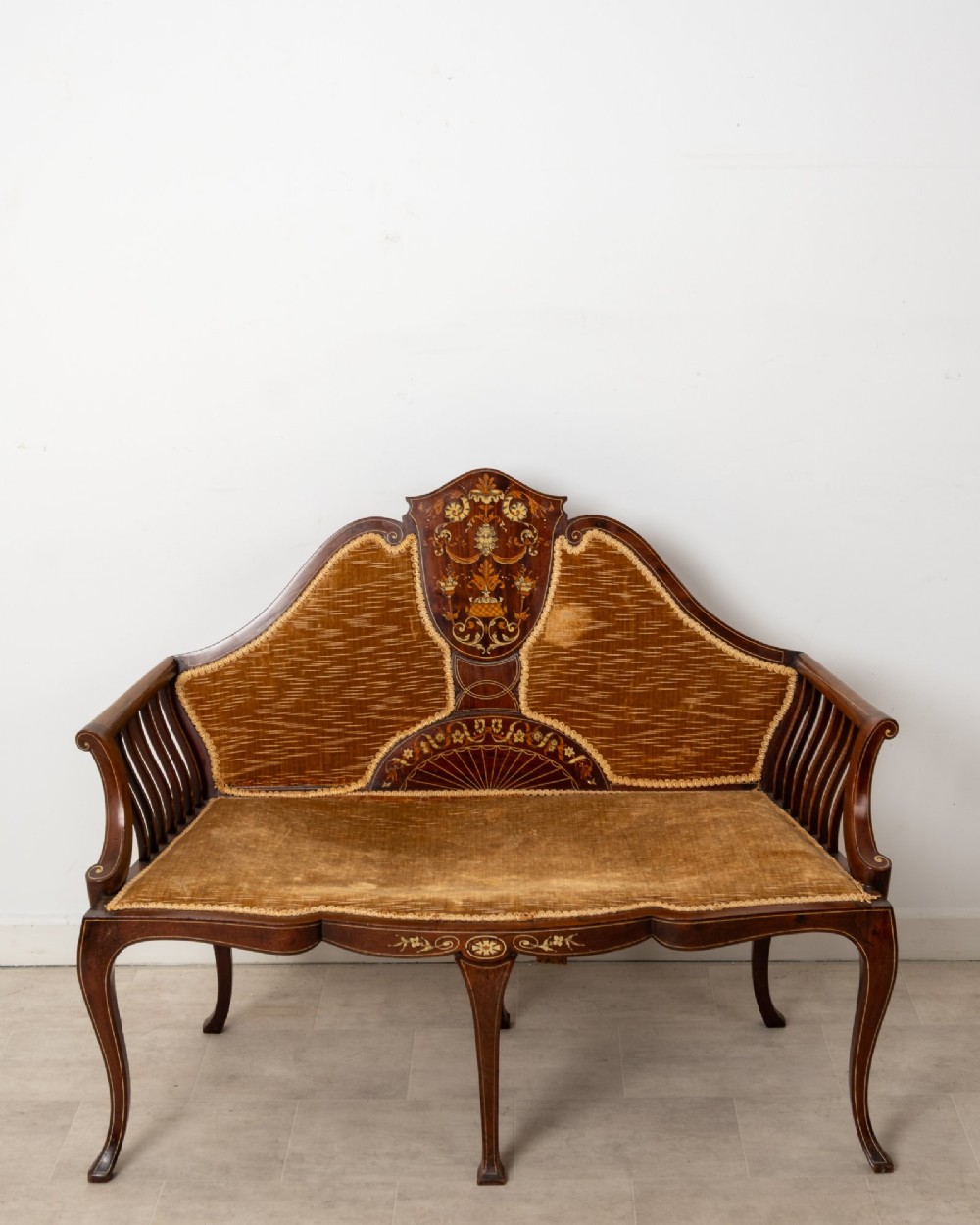 An Edwardian mahogany settee featuring floral marquetry inlay on a central back panel, slatted arms, cabriole legs, and gold-brown velvet upholstery. View III