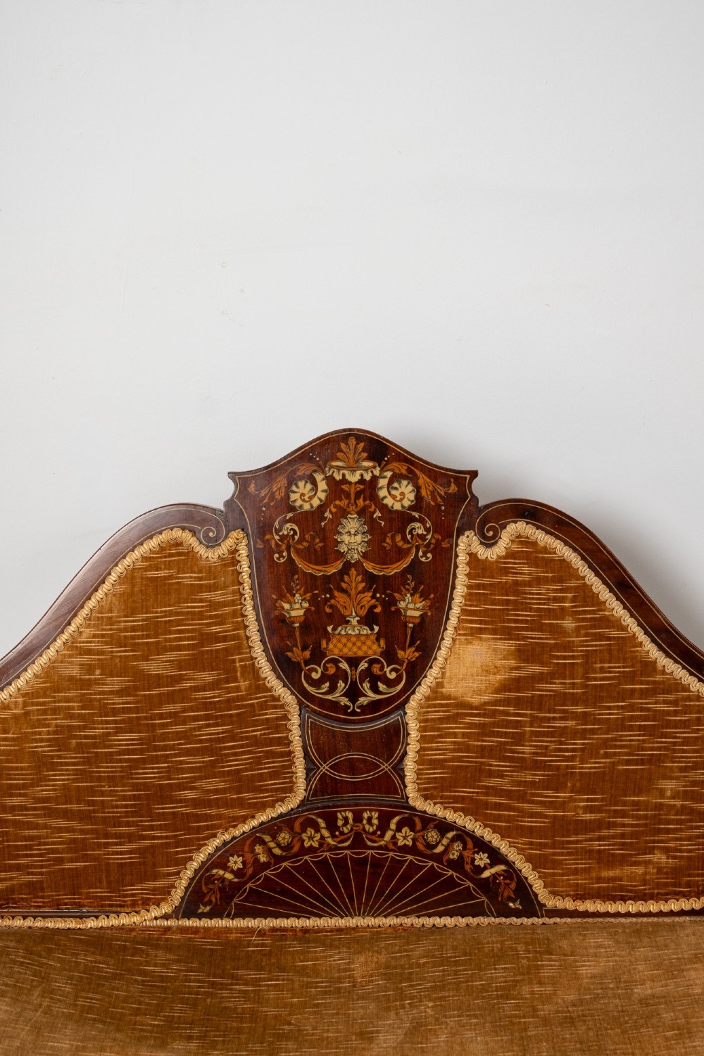 An Edwardian mahogany settee featuring floral marquetry inlay on a central back panel, slatted arms, cabriole legs, and gold-brown velvet upholstery. View IV