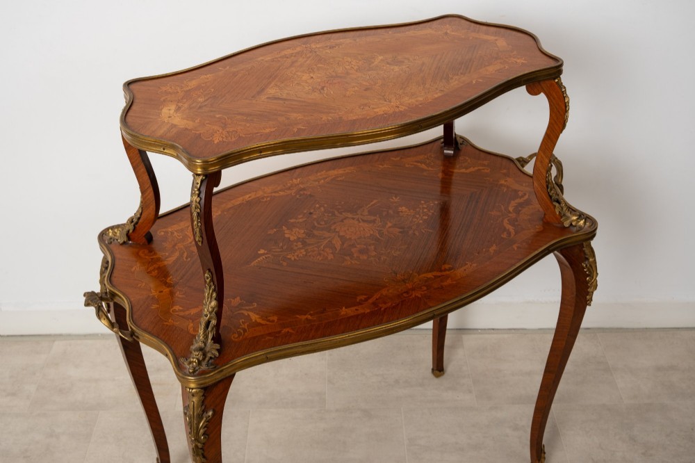 An antique Louis XV style two-tier kingwood side table featuring floral marquetry inlay, serpentine edges, and gilt-bronze mounts on cabriole legs. View V