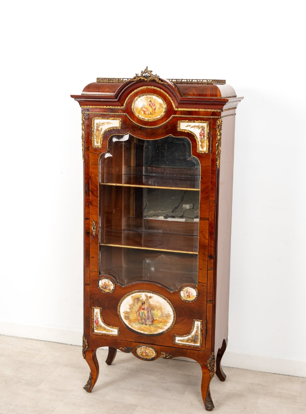 An antique French walnut vitrine featuring a single glass door, hand-painted porcelain plaques, gilt-bronze ormolu mounts, and cabriole legs. View III