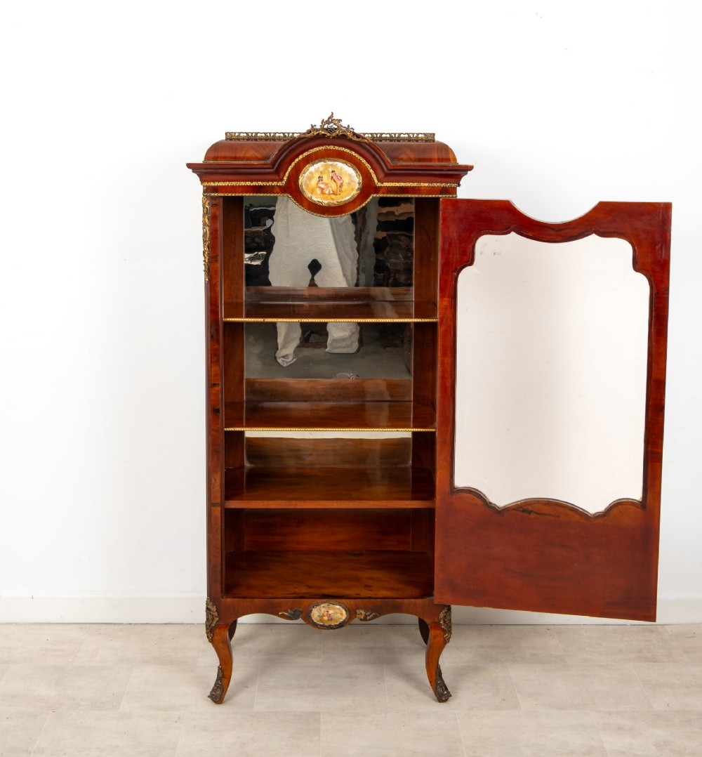 An antique French walnut vitrine featuring a single glass door, hand-painted porcelain plaques, gilt-bronze ormolu mounts, and cabriole legs. View VIII