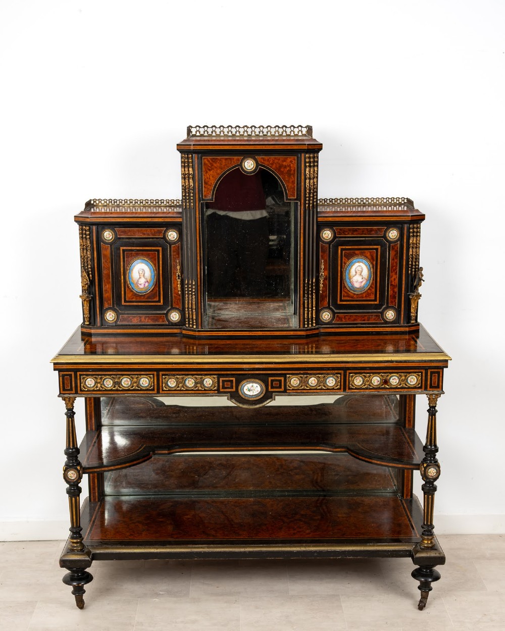 A nineteenth-century French ebonised and amboyna bonheur du jour desk featuring porcelain plaques, mirrored panels, turned legs, and brass mounts. View III