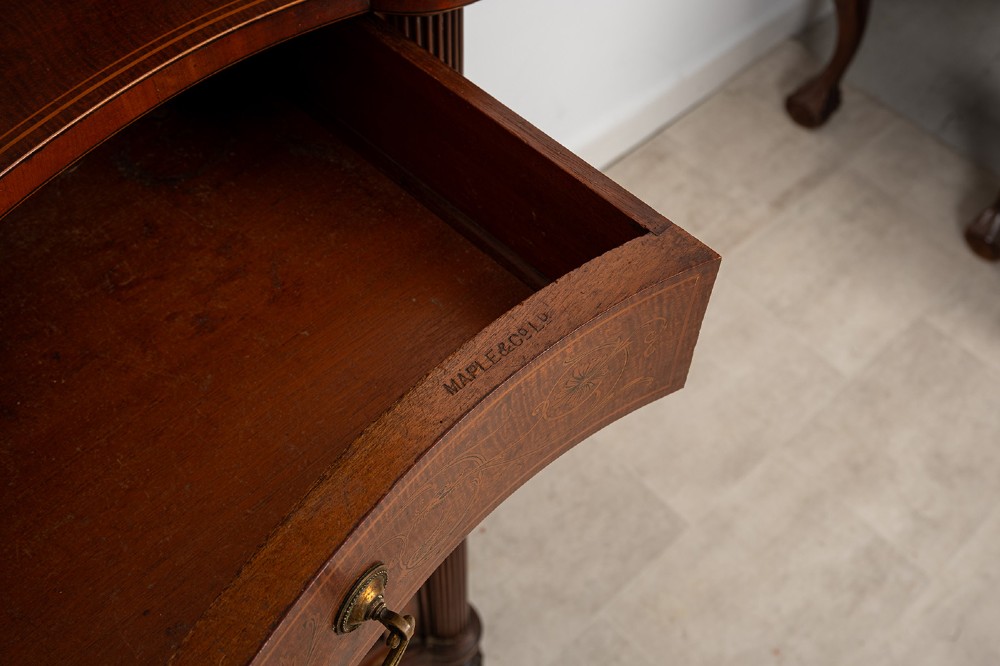 An Edwardian mahogany display cabinet featuring satinwood marquetry inlay, glazed upper doors with green fabric lining, and turned legs. View VIII