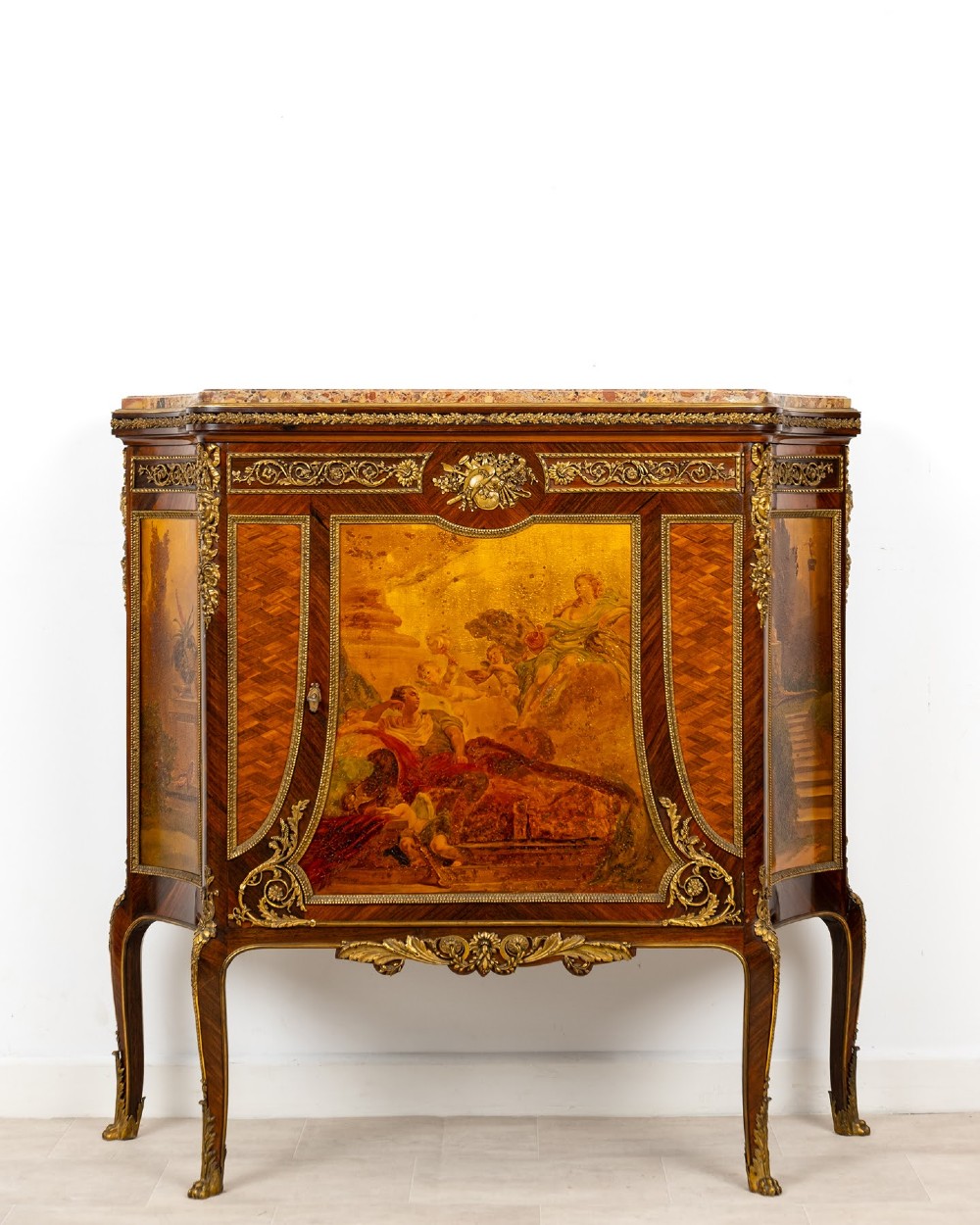 An antique French Louis XV revival side cabinet featuring hand-painted Vernis Martin panels, gilt-bronze mounts, and a shaped marble top.