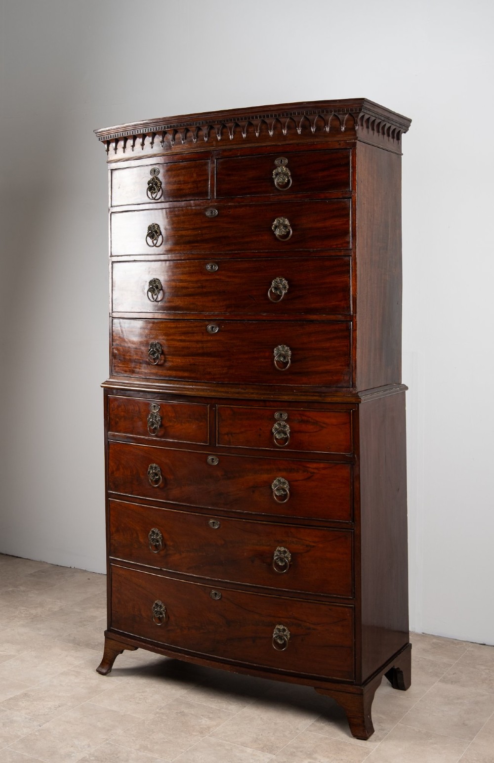 A tall Victorian bow front mahogany chest on chest featuring multiple drawer tiers with brass ring handles and upper cornice trim. View III